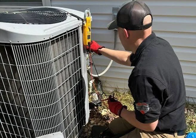 Technician servicing a residential outdoor heat pump