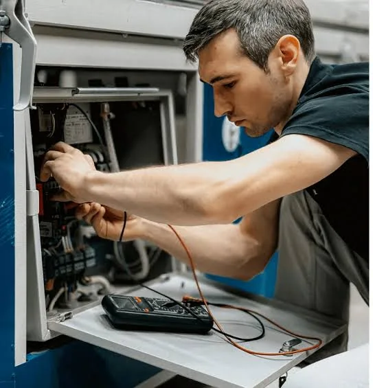 Technician inspecting the interior components of a residential air system